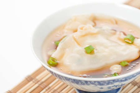 Bowl of wonton soup photographed closeup.  Selective focus to the center of the bowl.の写真素材
