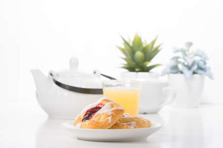 Fresh raspberry danish with coffee and orange juice.の写真素材