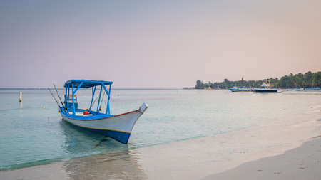 Traditional wooden boat in Honduras used to take tourists on fishing excursions photographed in the early morning.の写真素材