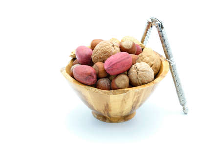Bowl of whole mixed nuts in the shell on a white background.の写真素材