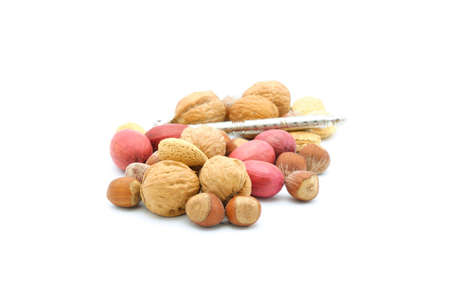 Mixture of nuts still in the shell on a white background.の写真素材