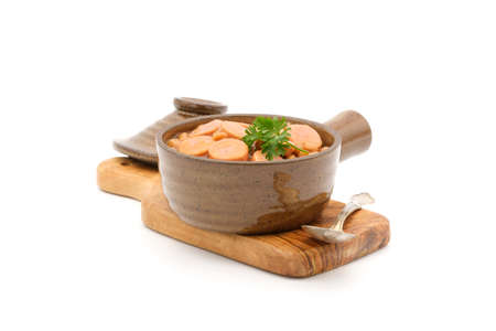 Bowl of slow baked brown beans and frankfurters photographed on a white background.の写真素材