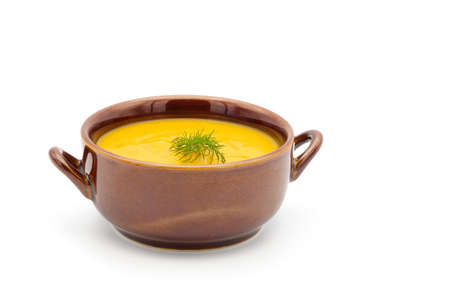 Bowl of homemade carrot dill soup photographed on a white background.の写真素材
