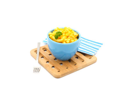 Blue bowl of creamy macaroni and cheese photographed on a white background.