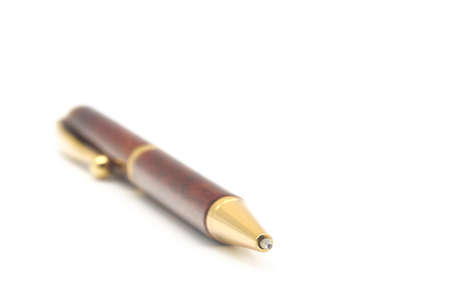 Photograph of high end ballpoint pen, shallow depth of field  with focus on the very tip of the nib on a white background with copy space.の写真素材