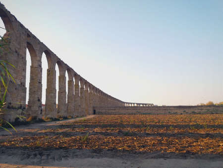 Beautiful ancient monument, a stone aqueduct that served to convey water with the background a blue skyの写真素材