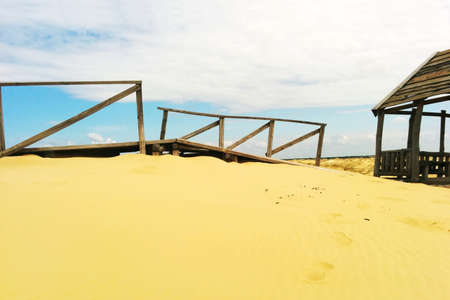 Desert  landscape. Wooden structures on sand.の写真素材
