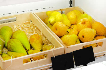 Fresh organic pears on shelf in supermarket. Vitamins and minerals.の写真素材