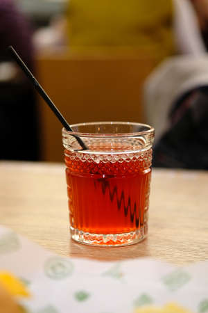 Glass of  Fruit Soda with straw is on the table in cafeの写真素材