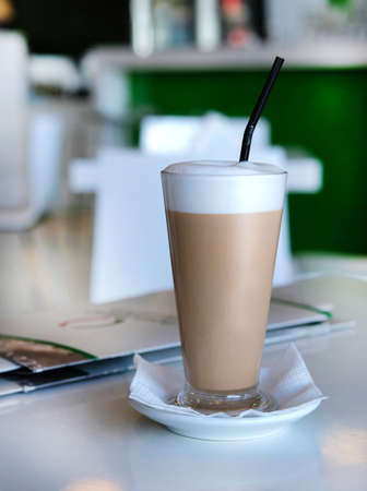 Glass with latte on blurred background on table in Italian cafeの写真素材