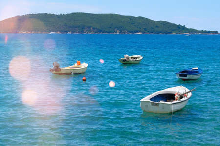 Boat parking in summer. Marina and boats moored in blue bay in Montenegro. Picturesque bay. Sunny...