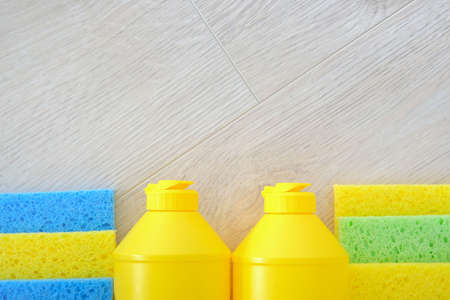 Service concept. Detergent in plastic bottle, sponges. Top view. Copy space. Flat lay.
