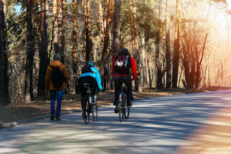 People riding bicycles in city park. Ride for exercise and relaxation. Healthy lifestyle. Sport and...