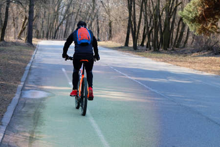 Man is riding on bicycle in a park. Ride for exercise and relaxation. Healthy lifestyle. Sport and...