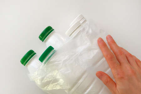 White plastic bottles on pile, ready to get recycled. Recycling of old plastic bottles. Ecology...