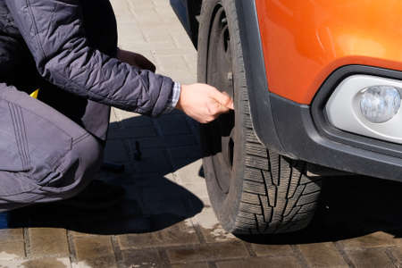 Removing rubber from the wheel disc. Car service. Changing a flat car tire on road. Auto repair concept.の写真素材