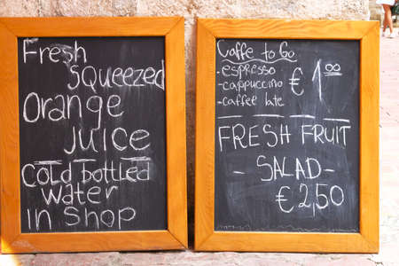 Menu board of small street cafe or restaurant.  Whiteboard with text of menu in an European city.