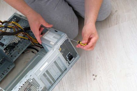 Computer engineer hold screwdriver for repairing PC. Service electronics and computers concept.