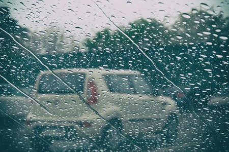 Rainy weather in city. Rain drops on glass is melancholy. Rainy day with dramatic weather, in...