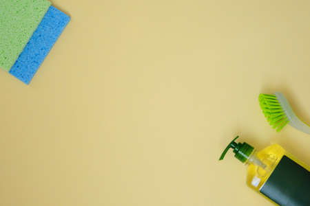 Cleaning products on yellow background. Microfiber, sponges and brush. Service concept. Flat lay. Copy space.の写真素材