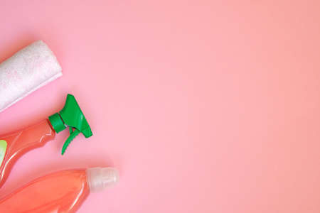 Cleaning service concept. Set with tools on pink background. Flat lay cleaning accessories. Top view.の写真素材