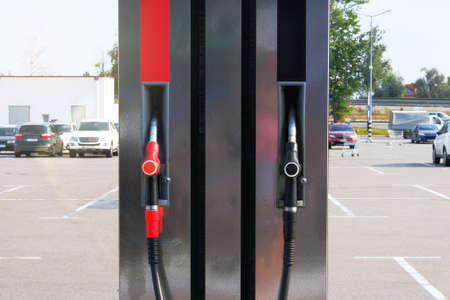 Black and red fuel pistols on fuel station. Gasoline and petrol products concept. Pumping petrol at...