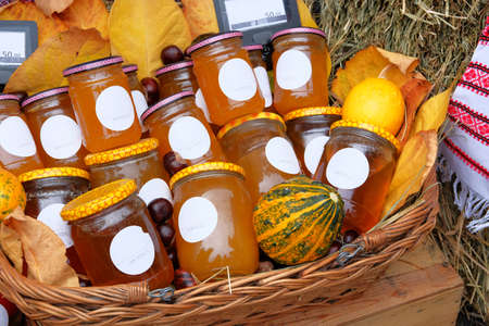 Jars with different types of honey in farmer agricultural market. Farm product in local market. Healthy food concept. Rustic style.の写真素材
