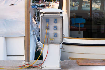 Electrical power sockets bollard on pier near sea coast. Charging station for boats in Croatia....
