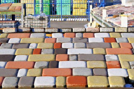 Bricks and tiles of pavement  at construction site. Warehouse paving slabs for laying road....