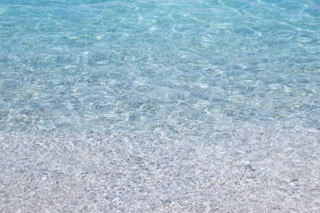 Blue transparent sea water texture. Background of tranquil ocean water. Summer vacation concept.の写真素材
