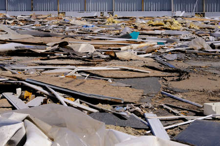 Construction garbage, cardboard, plywood, polyethylene after destruction of small buildings. Removal of debris. Bunch of trash.の写真素材