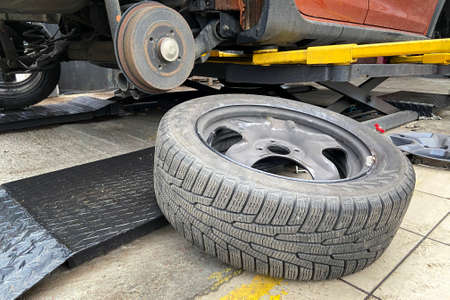 Car repair concept. Technicians are changing tires. Wheel balancing or repair and change car tire.