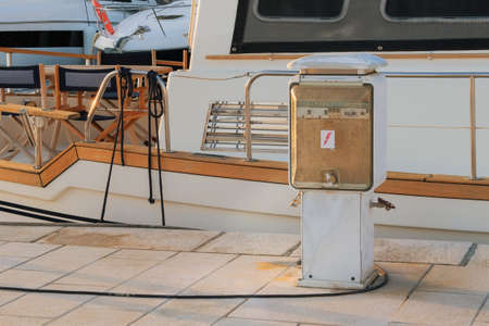 Refueling yachts with water on yacht dock in sea coast. Concierge service on the pier.