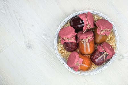 Fermented preserved sweet food concept. Variety of probiotics products and fermented foods in glass jars in white box in wooden background. Top view.の写真素材