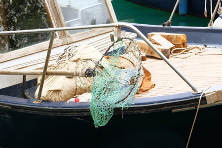 Fishing net on a fishing boat. Equipment on seacoast. Activity of catching fish, either for food or...