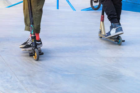 Skater boys having fun practicing at the outdoors skate park on a summer day. Active urban life....