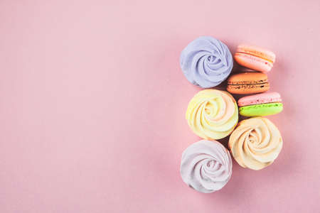 Traditional colored sweet desserts for the holiday, copy space. Desserts: macaroons, marshmallows...