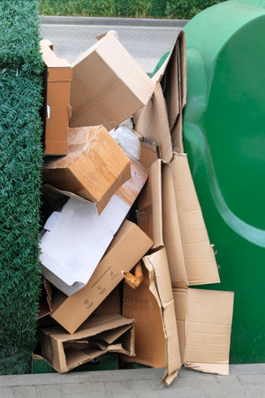 Pile of cardboard is sorting for recycled. Cardboard and waste paper is collected and packaged for recycling in city. Vertical view.の写真素材