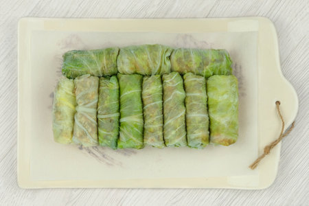 Frozen doves on a ceramic tray. Stuffed cabbage rolls are frozen. Top view.の写真素材