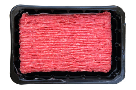 Mince in black container isolated on white background. Homemade minced meat. Cooking a burger.