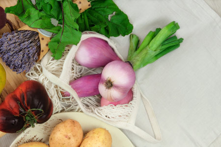 Shallots onions and other vegetables. Various of vegetables. Beets, tomatoes, potatos. Country style. Farming and harvesting. Top view.の写真素材