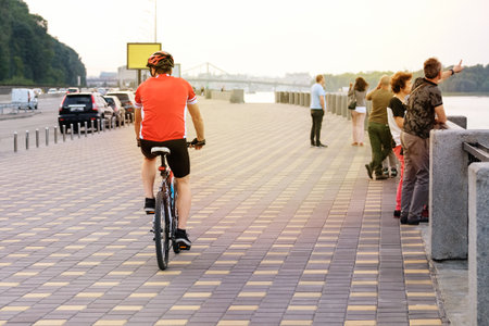 Cyclist spend their time on bicycle in city on sunny day. Ride for exercise and relaxation. Healthy lifestyle. Sport and active life concept.の写真素材