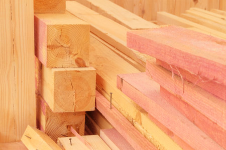 Stack of new wooden planks. Wooden planks on construction site. Construction of a wooden veranda....