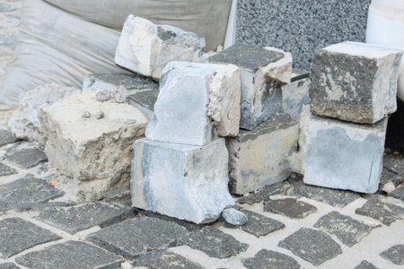 Gray bricks for repair. Pavement are laid on road. Road repair in city. New sidewalk.