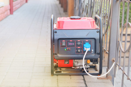 Diesel power generator. Business use mobile generator. Outdoor power supply generator placed on street sidewalk in city. Energy independence.の写真素材