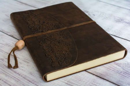 Classic Leather Bound Journal Book on a White Barn Board Floor Close Upの写真素材