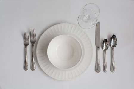 Formal Dinner Place Setting Utensils with White Wine Glassの写真素材