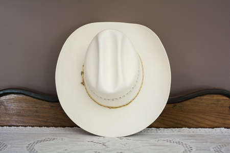 A White Cowboy Hat on an Antique Cabinet Front Viewの写真素材