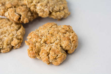Four oatmeal cookies on white counterの写真素材