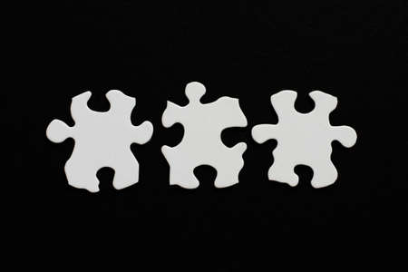 Three blank puzzle pieces inline unlinked on black background